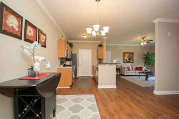 Louisville apartment for rent - A living room with a dining table and chairs.