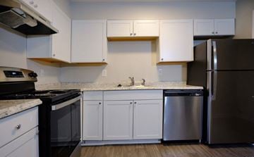 Morrow apartment for rent - A kitchen with white cabinets and a black stove top oven.