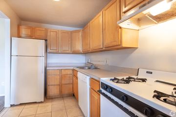 Bedford Heights apartment for rent - A kitchen with a white refrigerator and a white stove top oven.