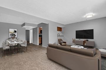 Indianapolis apartment for rent - A living room with a brown couch and a dining table.