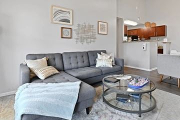 Columbus apartment for rent - A grey couch with a blue blanket on it in a living room.