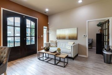 Carrollton apartment for rent - A living room with a white couch and a coffee table.