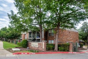 Mckinney apartment for rent - A brick building with a sign that says "Fire Lane" in front of it.