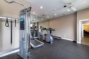 Mckinney apartment for rent - A gym with a treadmill, elliptical machines, and other exercise equipment.