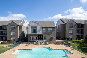 Carrollton apartment for rent - A large swimming pool in front of apartment buildings.