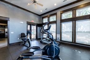 Denton apartment for rent - A gym with a row of treadmills and elliptical machines.
