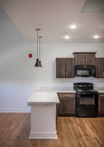 Abilene apartment for rent - A kitchen with a white counter top and dark brown cabinets.