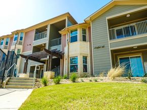 Longview apartment for rent - A building with a blue door and a balcony.
