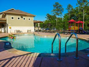 Longview apartment for rent - A small pool with a slide and a playground.
