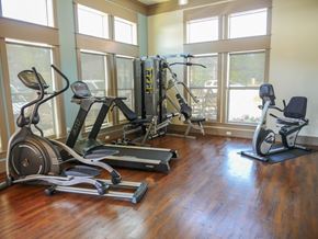Longview apartment for rent - A gym with a row of treadmills and elliptical machines.
