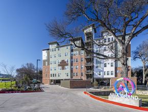 Austin apartment for rent - A tall apartment building with a sign that says "ARIA GRAND" in front of it.