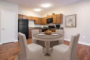 Abilene apartment for rent - A kitchen with a table and chairs in the middle of the room.