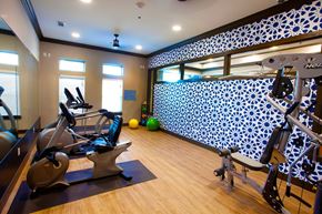 Waco apartment for rent - A gym with a row of treadmills and exercise bikes.
