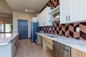 Irving apartment for rent - A kitchen with a blue refrigerator and wooden cabinets.