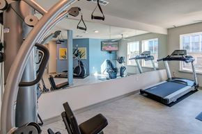Irving apartment for rent - A gym with a treadmill, elliptical machines, and other exercise equipment.