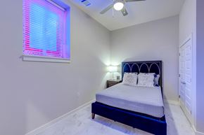 Ft Worth apartment for rent - A bedroom with a bed, pillows, and a ceiling fan.