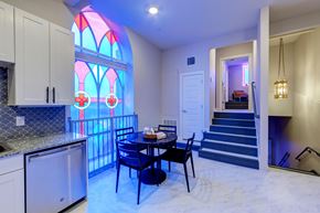 Ft Worth apartment for rent - A kitchen with a table and chairs and a stained glass window.