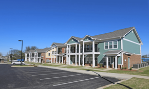 Montgomery apartment for rent - A large building with a parking lot in front.