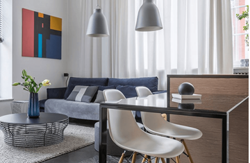 Montgomery apartment for rent - A modern living room with a grey sofa, a coffee table, and a painting on the wall.