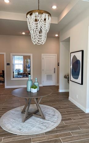 Tarpon Springs apartment for rent - A modern dining room with a round table and a chandelier.