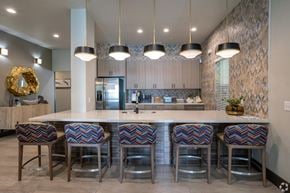 Austin apartment for rent - A kitchen with a white counter top and bar stools.