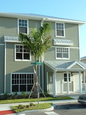 Punta Gorda apartment for rent - A grey two story house with a tree in front.