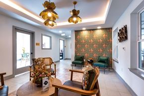 Dallas apartment for rent - A living room with a floral wallpaper and a wooden table.