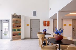 Dallas apartment for rent - A dining area with a table and chairs and a vase of flowers.