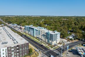 Austin apartment for rent - A parking lot is in the foreground of a city scene.