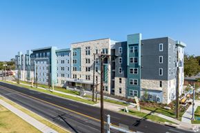 Austin apartment for rent - A street view of a row of modern apartment buildings.
