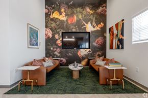 Austin apartment for rent - A living room with a large floral wallpaper and a brown leather couch.