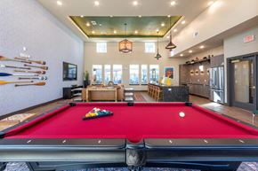 Arlington apartment for rent - A pool table is in the middle of a room with a red carpet.