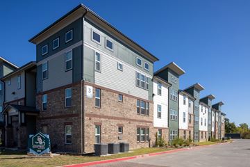 Arlington apartment for rent - A row of apartment buildings with a sign that says "Neighborhood".