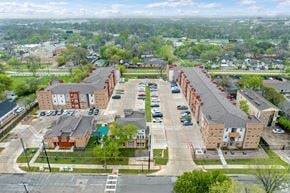 Dallas apartment for rent - A large parking lot is in front of a long building.