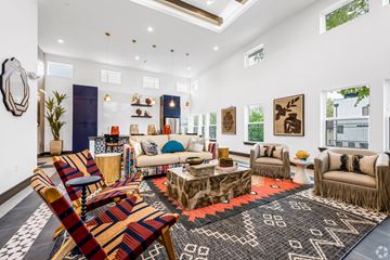 Dallas apartment for rent - A living room with a variety of furniture including a sofa, armchairs, and a coffee table.