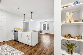 Dallas apartment for rent - A kitchen with white cabinets and a wooden floor.