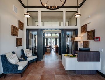 Austin apartment for rent - A modern living room with a blue patterned sofa and a wooden side table.