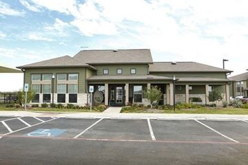 Abilene apartment for rent - A building with a parking lot in front of it.