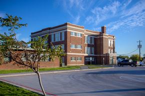 Abilene apartment for rent - A red brick building with a tree in front of it.