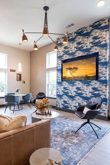 Grand Prairie apartment for rent - A living room with a large painting of a sunset on the wall.