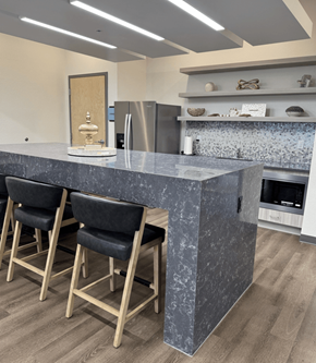 Ft Myers apartment for rent - A kitchen with a marble countertop and bar stools.
