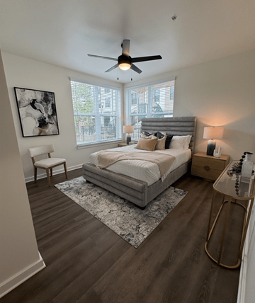 Ft Myers apartment for rent - A bedroom with a large bed and a ceiling fan.