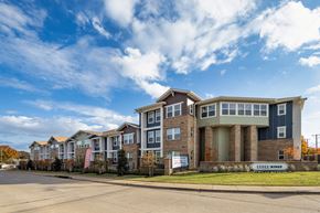 Arlington apartment for rent - A large multi-story building with a sign that reads "LivWell Ridge" in front of it.