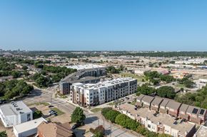 Plano apartment for rent - A cityscape with a mix of residential and commercial buildings.