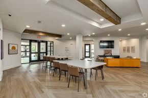 Plano apartment for rent - A conference room with a long table and chairs.