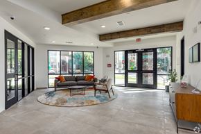 Plano apartment for rent - A spacious living room with a couch, coffee table, and a rug.