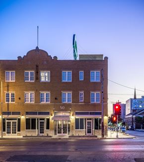San Angelo apartment for rent - A building with the number 50 on it is lit up at dusk.