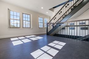 San Angelo apartment for rent - A spacious room with a staircase and large windows.