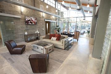 Tyler apartment for rent - A living room with a brown leather chair and a white couch.