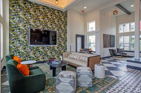 Austin apartment for rent - A living room with a green armchair and a patterned wallpaper.
